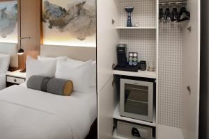a room with a white bed and a white stove at Hotel Indigo - NYC Downtown - Wall Street, an IHG Hotel in New York