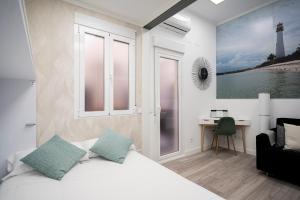 a bedroom with a bed and a desk with a lighthouse at Moncloa Apartment in Madrid