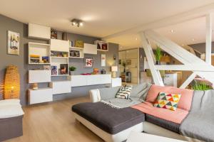 a living room with a couch and some shelves at Le Victor Hugo Appartement T3 proche Musée Soulages in Rodez