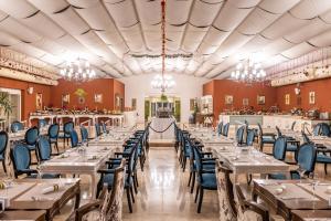 a banquet hall with tables and chairs and chandeliers at Grand Pasha Hotel & Spa Kyrenia in Kyrenia
