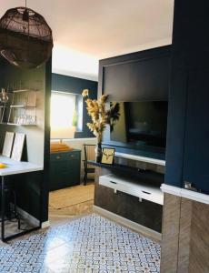 a living room with a flat screen tv on a wall at Apartament Zamkowy 2 in Kwidzyn