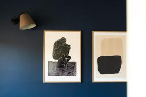 two framed pictures of a statue on a wall at Apartament Zamkowy 2 in Kwidzyn