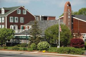 a large red brick building with a flag in front of it at Lamies Inn & The Old Salt Tavern in Hampton
