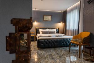 a hotel room with a bed and a chair at HIDDEN BANK: Digger's Dream in Plovdiv