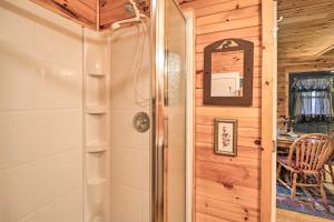 a bathroom with a shower and a shower stall at Peaceful Mountain City Cabin with Porch and Fire Pit in Mountain City +19 photos