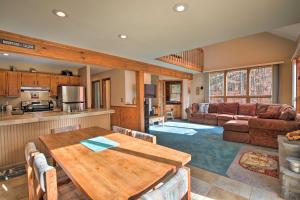 a kitchen and living room with a wooden table at Elka Park Townhome with Views about 5 Mi to Skiing! in Elka Park