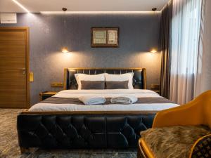 a bedroom with a large bed with two towels on it at HIDDEN BANK: Digger's Dream in Plovdiv