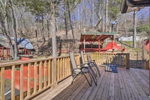 a deck with two chairs and a playground at Peaceful Cookeville Cabin on 52 Acres! in Cookeville +16 photos