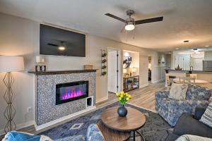 a living room with a fireplace with a tv at Welcome to After Dune Delight Golf Course Condo! in Pawleys Island