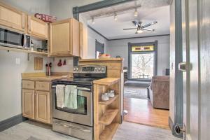 a kitchen with wooden cabinets and a stove top oven at Quaint Helena Apartment - Walkable to Downtown! in Helena