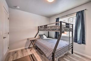 a bedroom with two bunk beds and a window at Kenai Home with Fireplace Less Than 10 Mi to Big Eddy! in Kenai