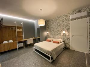 a bedroom with a bed in a room with a closet at La Taverna Antica Rooms in Pescara