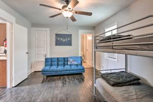 a bedroom with a bunk bed and a blue couch at Cozy Galveston Apartment - Walk to Beach and Dining in Galveston