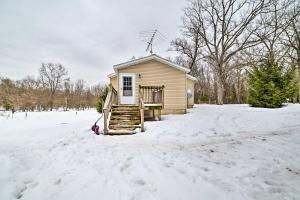 a small house in the snow in a yard at Spacious Wellston Home Near Hiking and Skiing! in Wellston