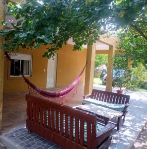 a hammock on the porch of a house at Casa a 5 km de Villa de Las Rosas in Las Tapias