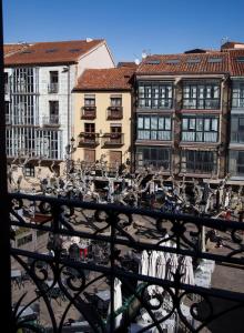 a view of a city from a balcony with buildings at Hotel Soria Plaza Mayor in Soria