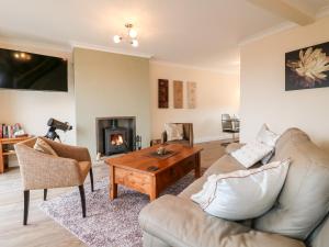 a living room with a couch and a table at Hollinwell View in Nottingham