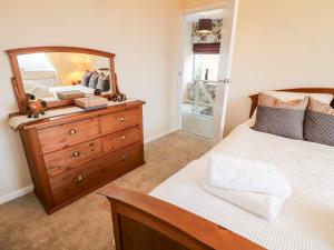 a bedroom with a dresser with a mirror on it at Hollinwell View in Nottingham