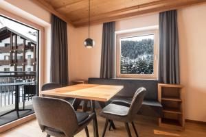a dining room with a table and chairs and a window at La Grambla App Sella 1 in Santa Cristina in Val Gardena