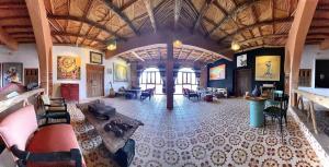 a large room with couches and chairs in a building at taman'art space in Aït Benhaddou