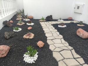 a garden with rocks and a stone pathway at La Duomo di Vulcano in Playa Honda