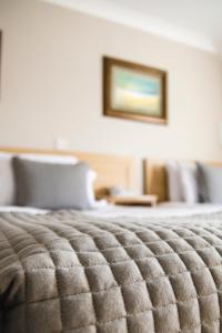 a close up of a bed in a hotel room at The Harbour Inn in Buncrana