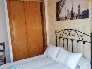 a bedroom with a bed and a wooden door at Las Cuatro Lunas in Níjar