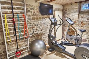 a gym with two exercise bikes and a tv at Demeure de Manneville - SPA - 1Km des plages de Cabourg in Dives-sur-Mer