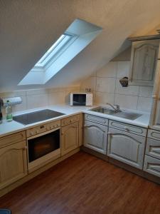 a kitchen with a sink and a stove top oven at Fewo Rietberg in Rietberg