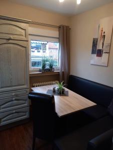 a dining room with a table and a window at Fewo Rietberg in Rietberg