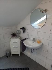 a bathroom with a sink and a mirror at Fewo Rietberg in Rietberg