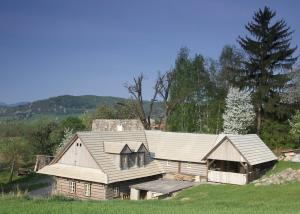 a large wooden house in the middle of a field at Drevenica pod orechom in Detva