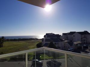 a balcony with a view of the ocean at Cascades Self-Catering Apartments in Summerstrand +3 photos
