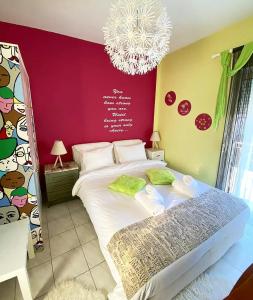 a bedroom with a large bed and a chandelier at Alexandras cozy apartment Ioannina in Ioannina