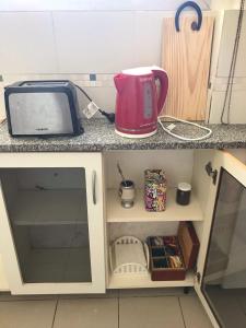 a kitchen counter with a microwave and a toaster at Mira Bosques 3 in La Plata +6 photos
