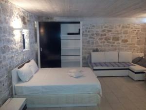 a bedroom with a large bed and a couch at Cosy Studio with breathtaking view in Gaios