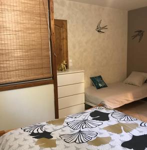 a bedroom with two beds and a window at Ch'ti NID au pays des lacs in Alièze