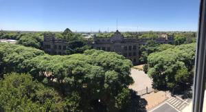 an old building with trees in front of it at Mira Bosques 3 in La Plata