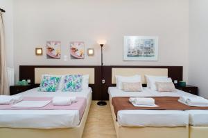 two beds in a room with white walls at Villa Yanna in Olympiada +62 photos