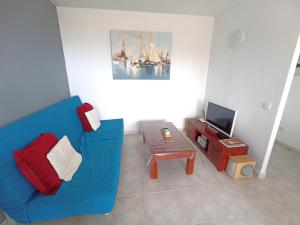 sala de estar con sofá azul y mesa en Playa, en Miami Platja