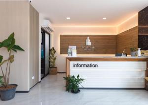 an office lobby with a reception desk and a counter at Napa Hotel Ratchaburi in Ratchaburi