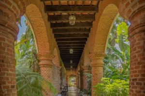 an arcade of a building with a brick wall at Porta Hotel Antigua in Antigua Guatemala