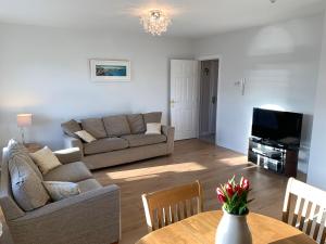 a living room with a couch and a table at Millfield Holiday Village in Portstewart