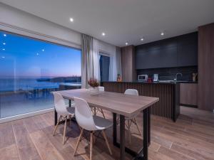 a kitchen and dining room with a table and chairs at Horizon Two bedroom Penthouse with Hot tub in Becici