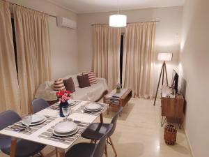a living room with a table and a couch at Blue Yard Apartments in Kalamata