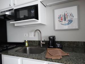 a kitchen counter with a sink and a microwave at The Chicago Hotel Collection Millennium Park in Chicago