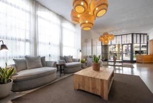 a living room with a couch and a table at Ohia Waikiki Studio Suites in Honolulu