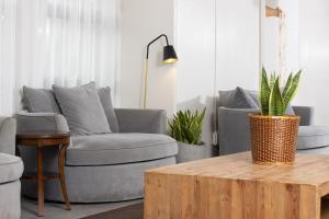 a living room with a couch and a coffee table at Ohia Waikiki Studio Suites in Honolulu +32 photos