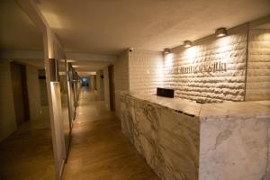 a lobby with a marble counter and lights on the wall at Hotel Santa Cecilia B&B in Cartagena de Indias