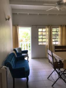 a living room with two chairs and a couch at Diamond Gem Residence in Koolbaai